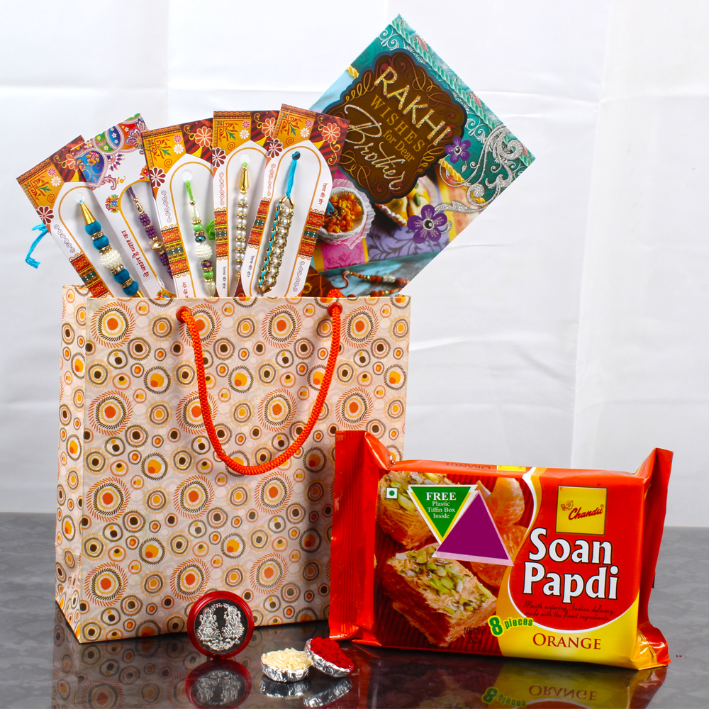 Bag of 5 Rakhis with Orangy Soan Papdi and Laxmi Ganesha Silver Coin