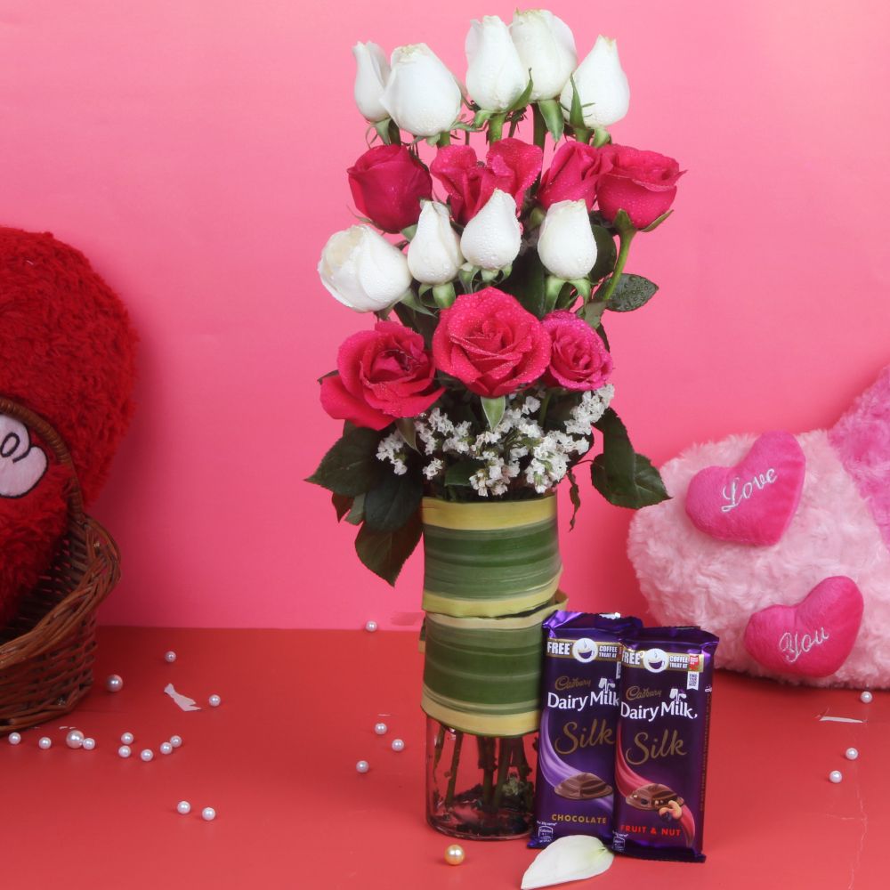 Glass Vase of Pink and White Roses and Chocolates