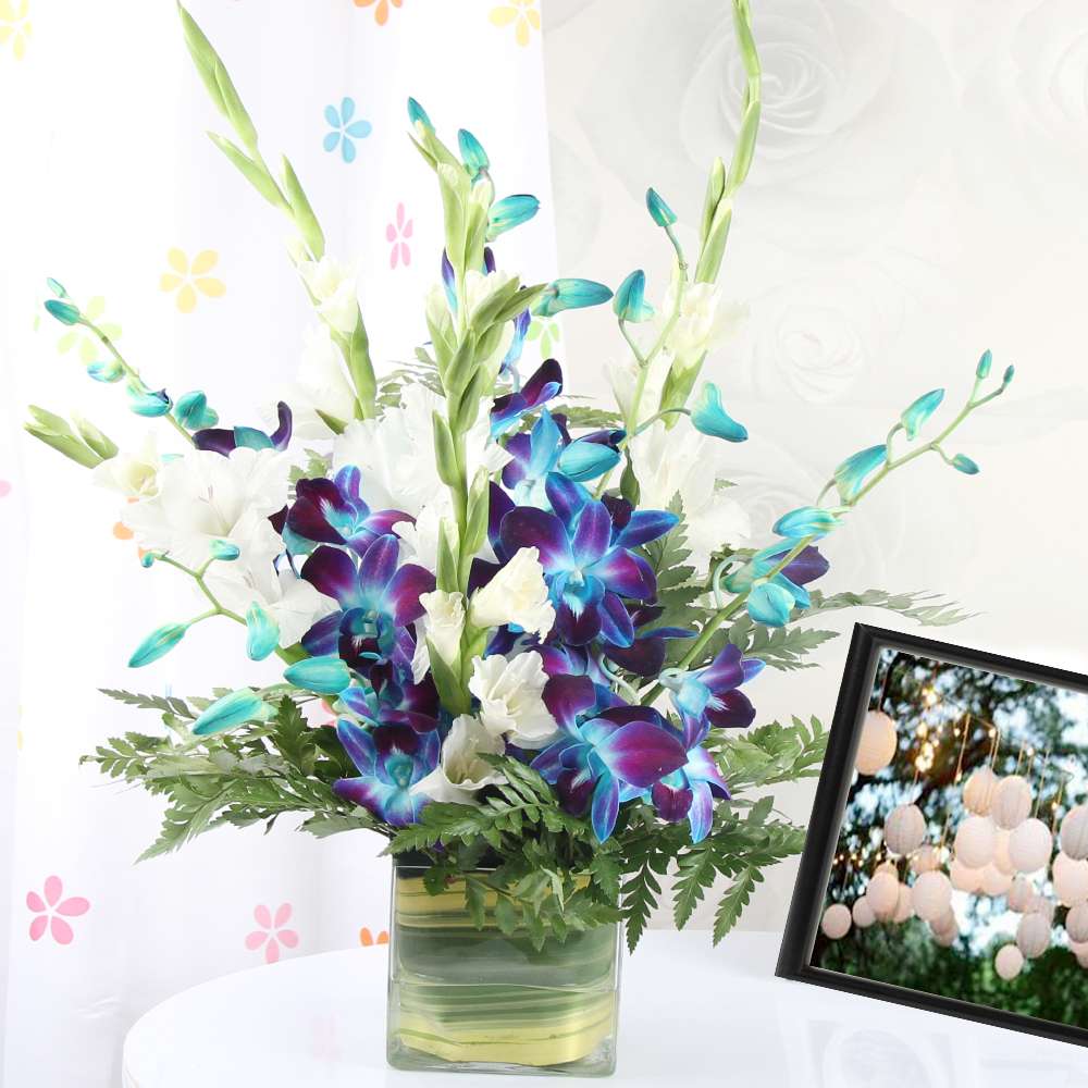 Blue and White Orchids in a Glass Vase