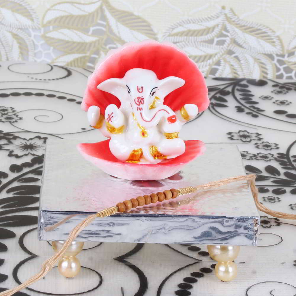 Shell Covered Ganesha Idol on Designer Chowki with Rakhi