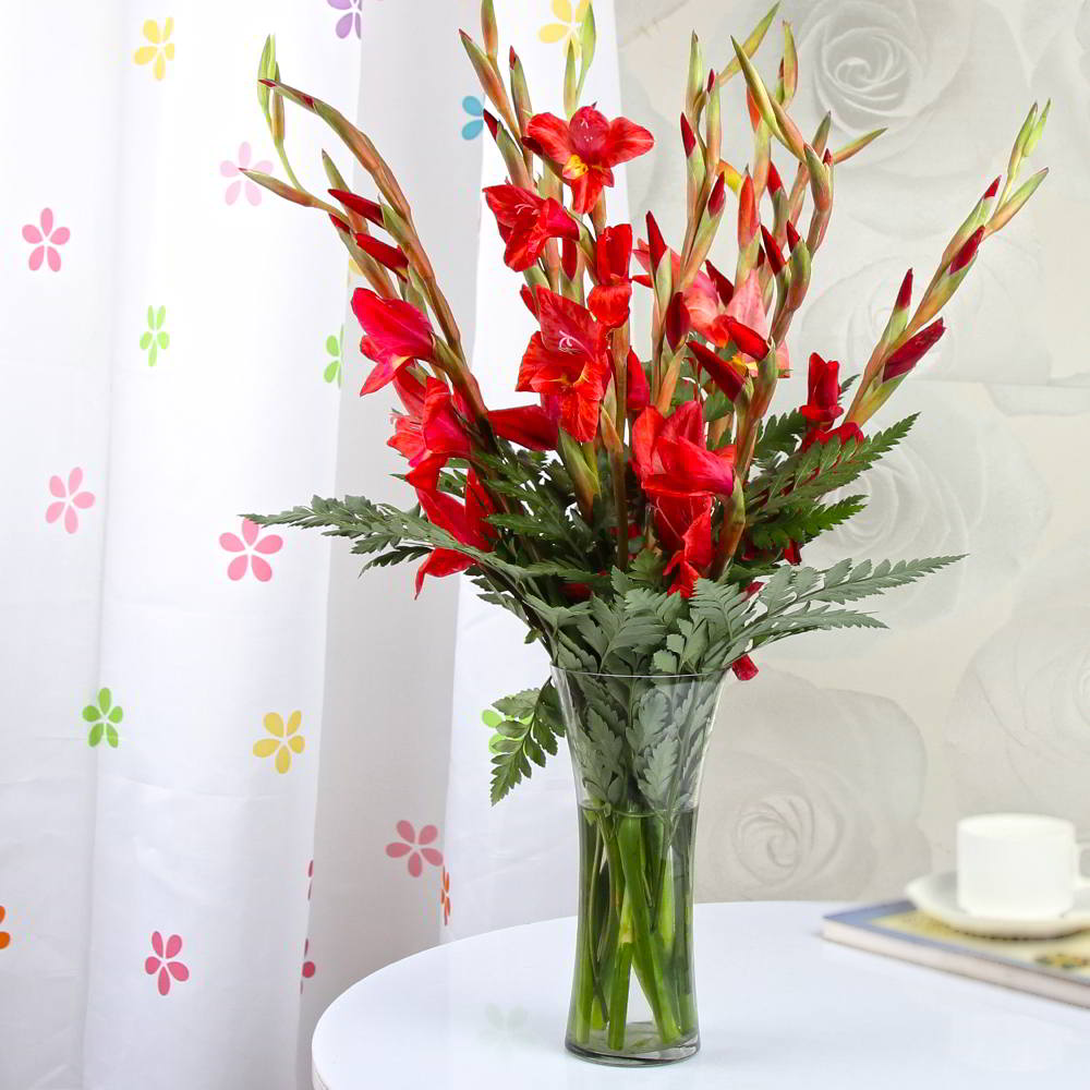 Red Glads in a Glass Vase for Mumbai