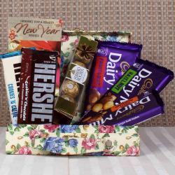 Send New Year Gift New Year Treat Dairy Milk with Hersheys and Rocher Hamper To Rajkot