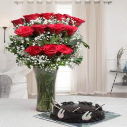 Send Round Shape Chocolate Cake with Red Roses Arrangement To Chittoor