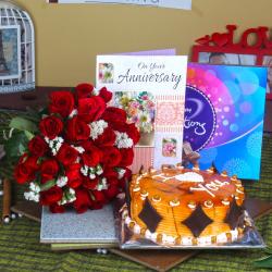 Send Red Roses Bouquet with Celebration Chocolates and Butterscotch cake Anniversary Greeting Card To Blimora