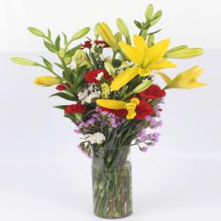 Send Glass Vase of Lilies and Carnations To Bhubaneshwar