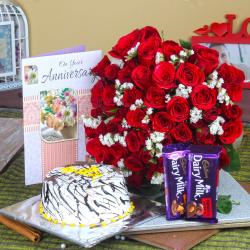 Send Anniversary Half kg Vanilla Cake and Fifty Red Roses with Chocolates To Krishna
