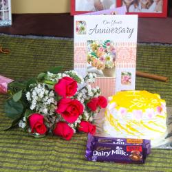 Send Anniversary Roses with Eggless Cake and Fruit n Nut Chocolates To Kupwara