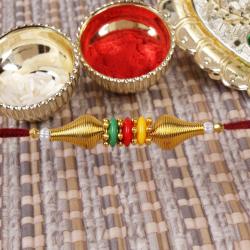 Send Rakhi Gift Trio Colors Beads with Golden Beads Rakhi To Ahmedabad