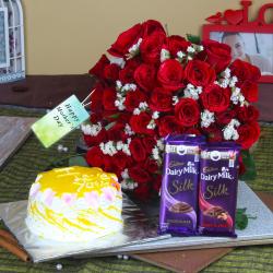 Mothers Day Gifts to Ghaziabad - Fifty Red Roses Bouquet with Silk Chocolate and Pineapple Cake