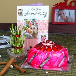 Send Anniversary Card with Strawberry Cake and Good Luck Plant To Kolkata