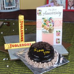 Send Chocolate Cake and Anniversary Card with Toblerone Chocolates To Delhi