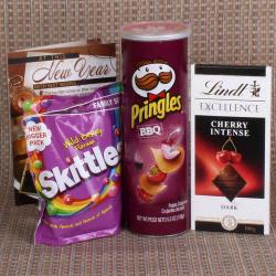 Send New Year Gift Pringle and lindt with Skittle Chocolate for New Year To Ahmedabad