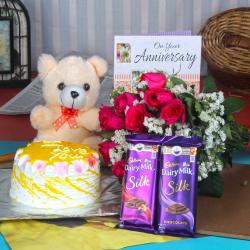 Send Anniversary Cake with Silk Chocolates and Teddy Hamper To Erode