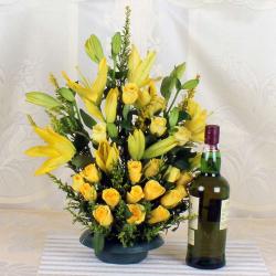 Send Birthday Gift Arrangement of Yellow lilies and Roses with Bottle of Wine To Mangalore