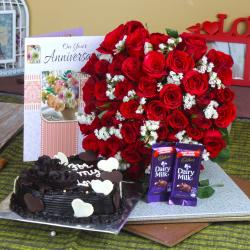 Send Anniversary Heart Shape Chocolate Cake and Fifty Roses Bunch with Chocolates To Jhansi