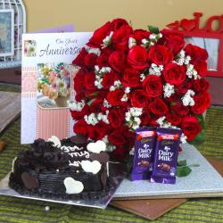 Send Anniversary Heart Shape Chocolate Cake and Fifty Roses Bunch with Chocolates To Gorakhpur